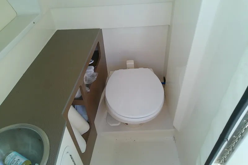 Slide: The Image of Interior of 2015 Sea Ray SDX 270 Outboard boat bathroom with toilet and sink. - 38
