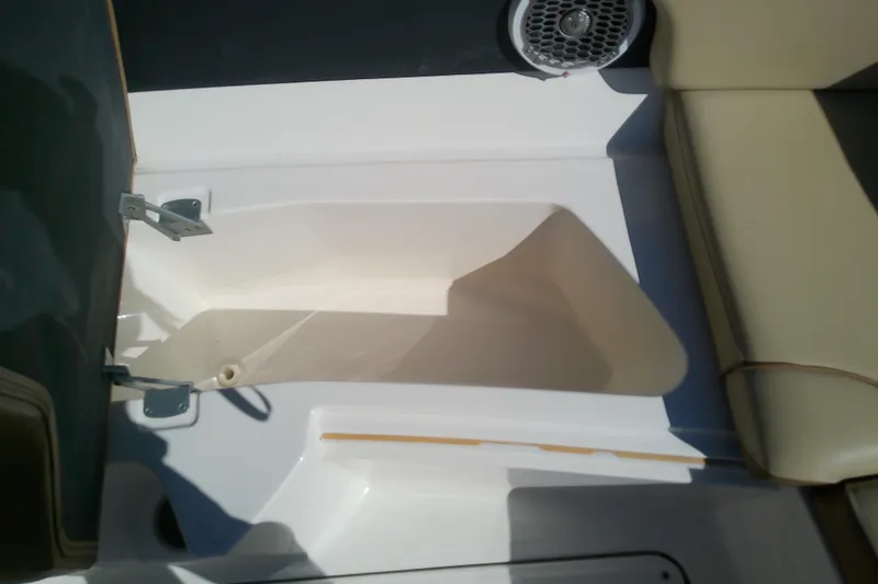 Slide: The Image of Open storage compartment on 2015 Sea Ray SDX 270 Outboard boat. - 34