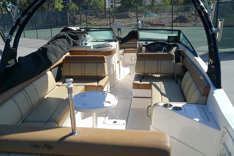 Slide: The Image of 2015 Sea Ray SDX 270 Outboard boat interior with beige seating and table. - 15