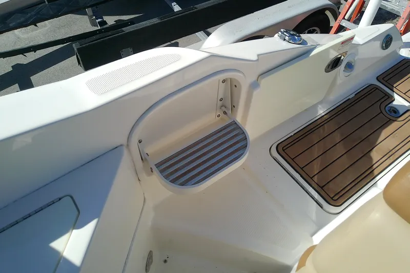 Slide: The Image of 2015 Sea Ray SDX 270 Outboard boat interior with step and wood-patterned flooring. - 43