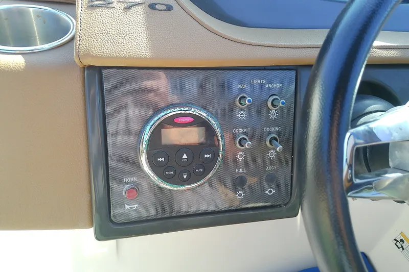 Slide: The Image of Control panel of 2015 Sea Ray SDX 270 Outboard boat with steering wheel and switches. - 25