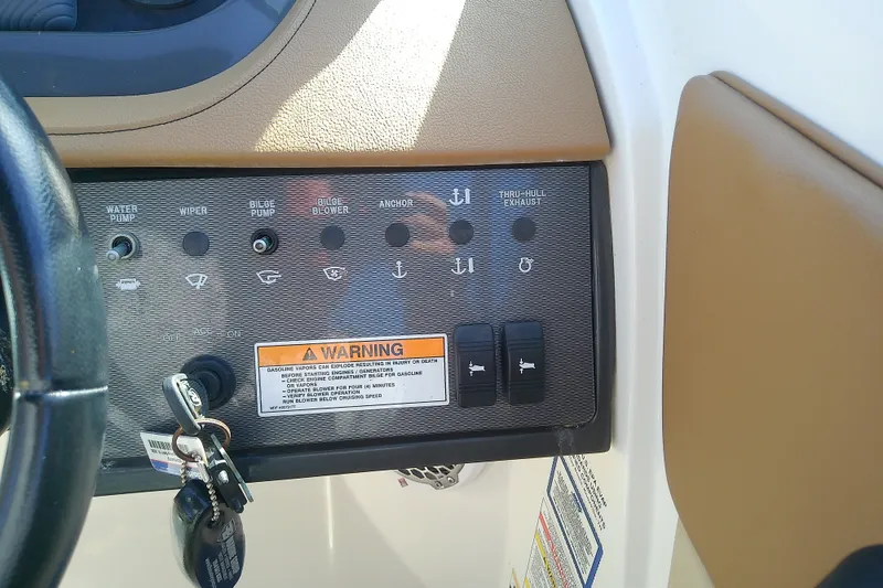 Slide: The Image of Control panel of a 2015 Sea Ray SDX 270 Outboard boat with warning label. - 26