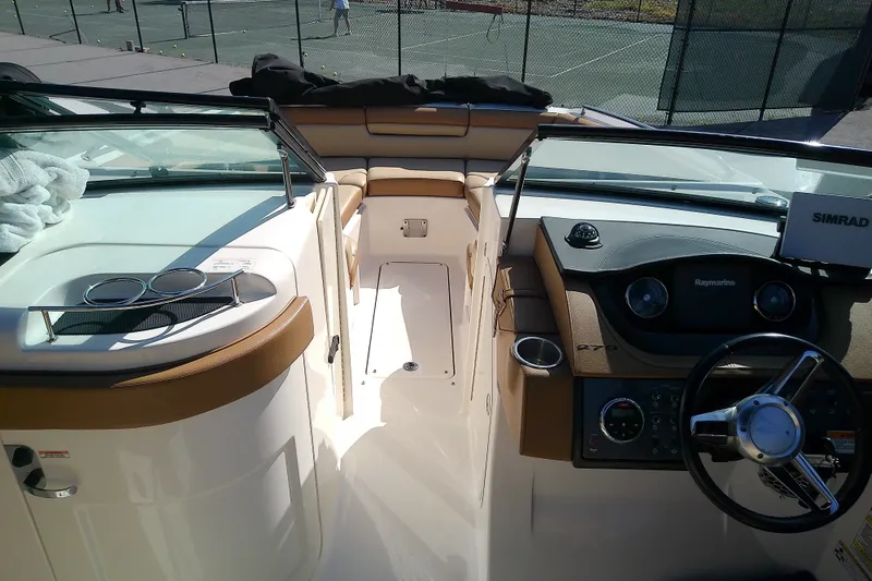 Slide: The Image of Interior view of 2015 Sea Ray SDX 270 Outboard boat cockpit with steering wheel and controls. - 28