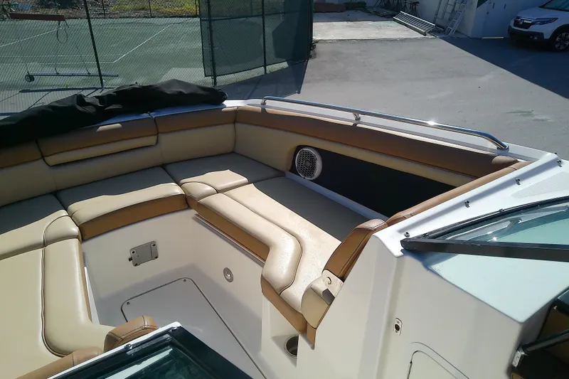 Slide: The Image of 2015 Sea Ray SDX 270 Outboard boat interior with tan seating and speaker. - 29