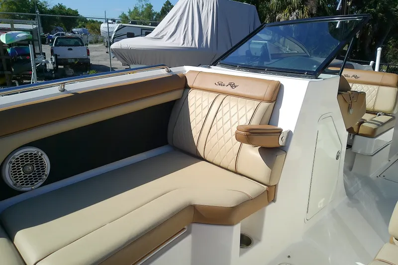 Slide: The Image of 2015 Sea Ray SDX 270 Outboard boat interior with tan leather seating and speaker. - 32