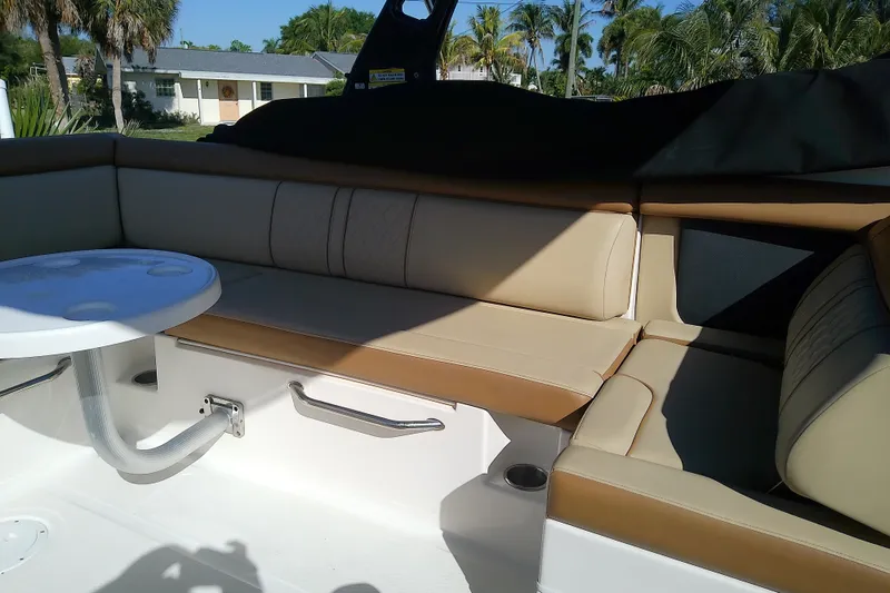 Slide: The Image of 2015 Sea Ray SDX 270 Outboard interior with beige seating and round table. - 19