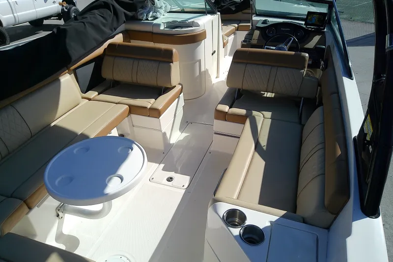 Slide: The Image of 2015 Sea Ray SDX 270 Outboard boat interior with beige seating and round table. - 17