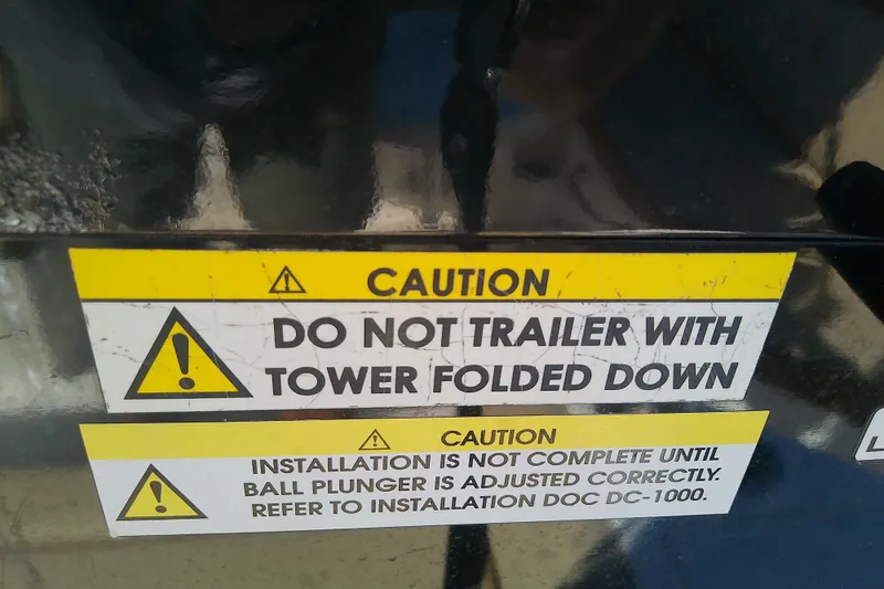 Slide: The Image of Caution labels on Sea Ray SDX 270 Outboard, warning about tower and installation. - 41