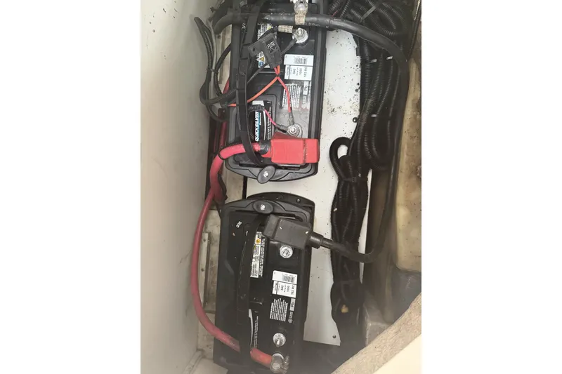 Slide: The Image of Battery compartment of 2015 Sea Ray SDX 270 Outboard with wiring and connections. - 44