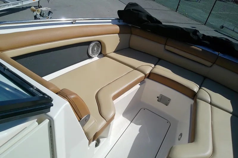 Slide: The Image of 2015 Sea Ray SDX 270 Outboard boat interior with tan seating and speaker. - 30