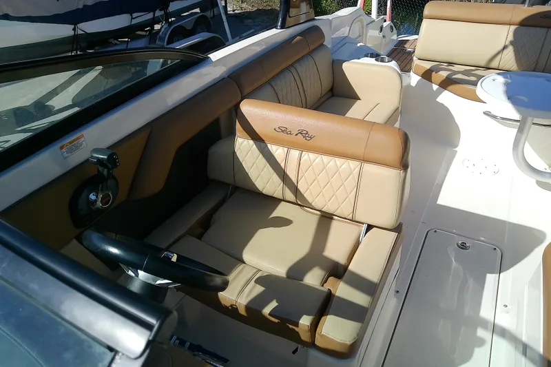Slide: The Image of 2015 Sea Ray SDX 270 Outboard interior with tan leather seating and steering wheel. - 22