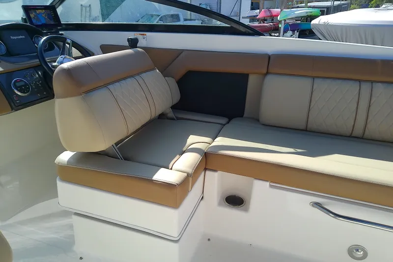 Slide: The Image of Interior of 2015 Sea Ray SDX 270 Outboard boat with beige seating and dashboard. - 21
