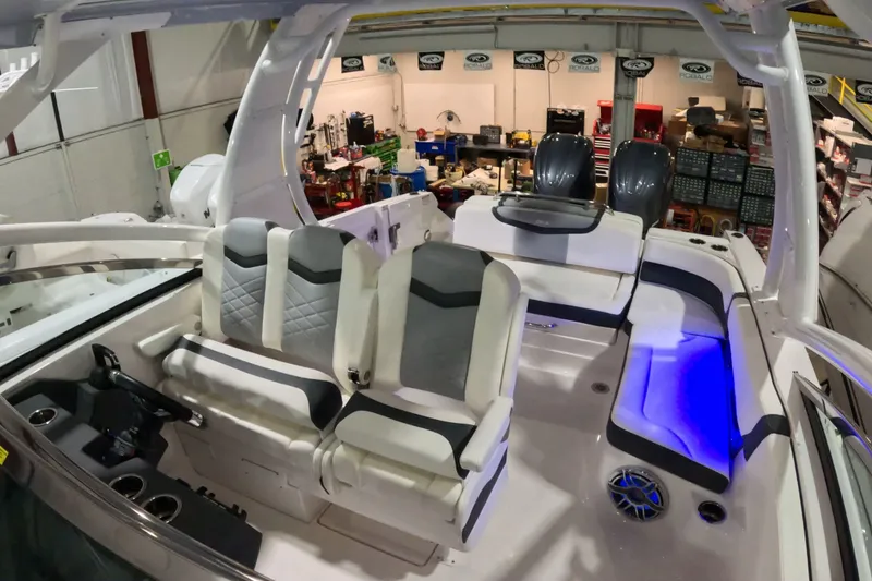 Slide: The Image of 2023 Chaparral 280 OSX boat interior with modern seating and blue LED lighting. - 7