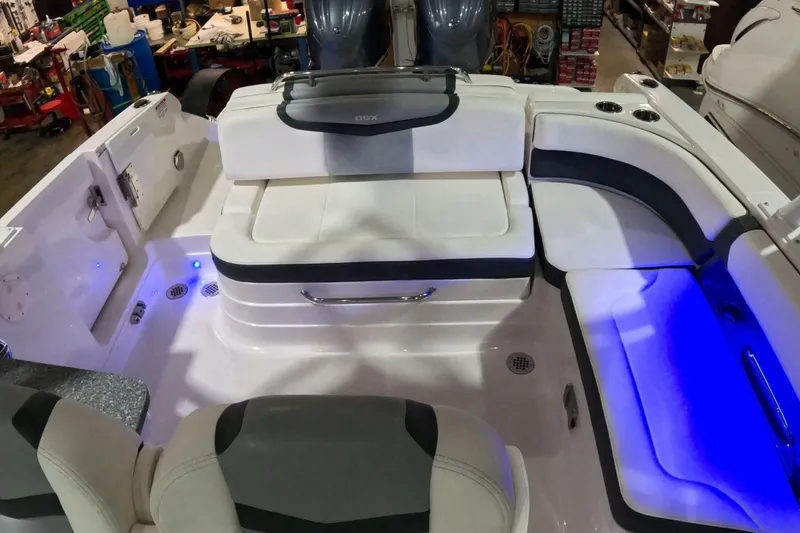 Slide: The Image of 2023 Chaparral 280 OSX boat interior with white seating and blue LED lighting. - 10