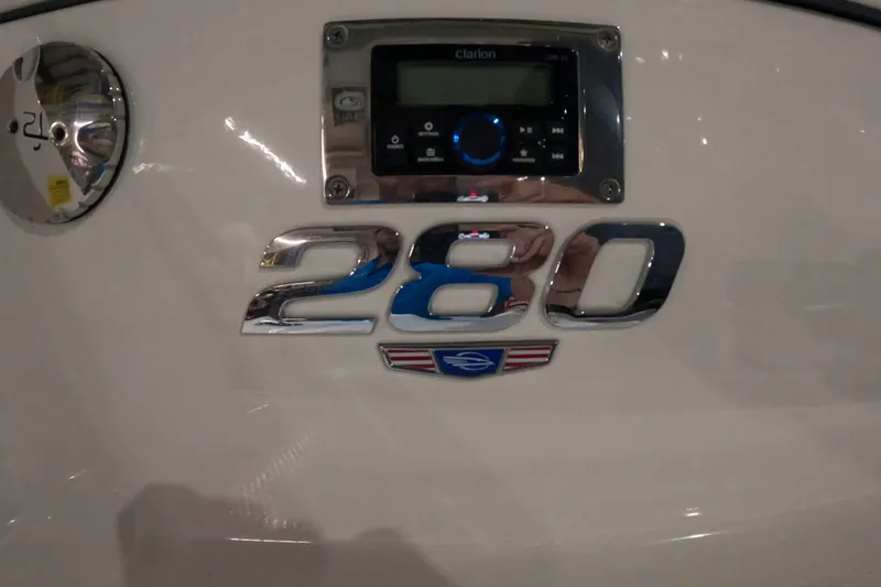 Slide: The Image of 2023 Chaparral 280 OSX boat emblem with audio system display. - 12