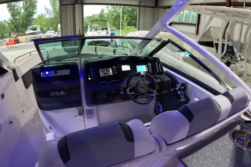 Slide: The Image of 2023 Chaparral 280 OSX boat interior with modern dashboard and seating. - 5