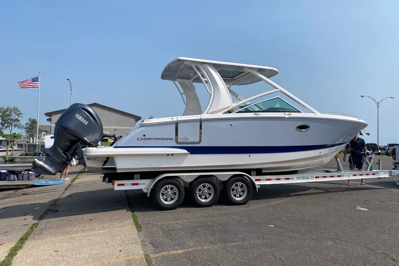 Slide: The Image of 2023 Chaparral 280 OSX boat on trailer with Yamaha engine at dockside. - 1
