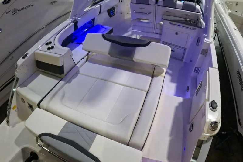 Slide: The Image of 2023 Chaparral 280 OSX boat interior with luxurious seating and ambient blue lighting. - 4