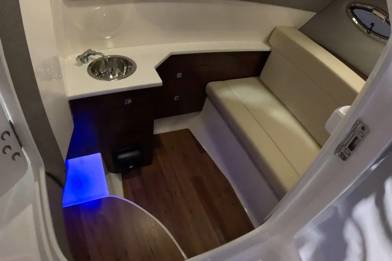 Slide: The Image of Interior of 2023 Chaparral 280 OSX boat with seating, sink, and ambient lighting. - 11