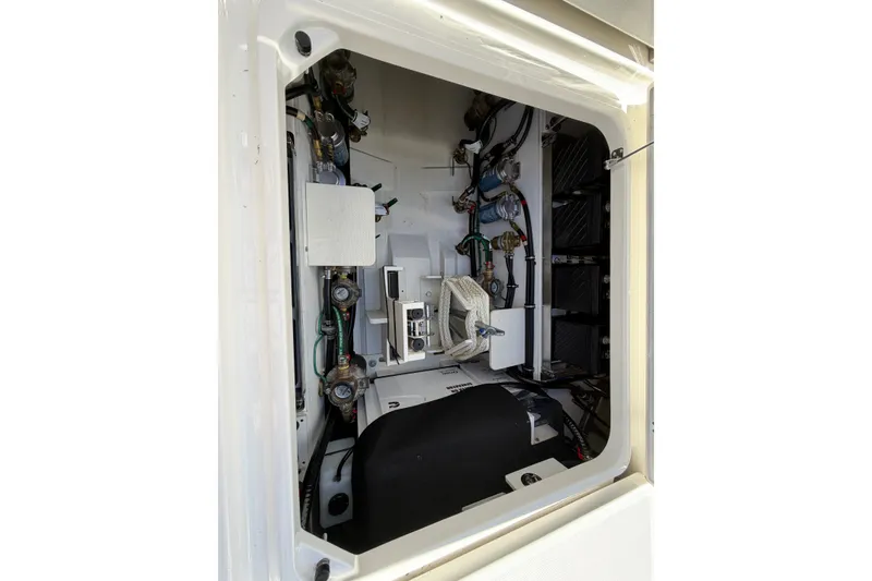 Slide: The Image of 2023 Pursuit S 428 Sport boat engine compartment with wiring and components. - 29