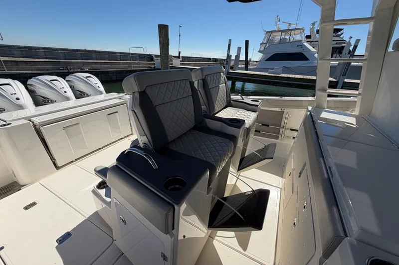Slide: The Image of 2023 Pursuit S 428 Sport boat interior with luxurious seating and powerful outboard engines. - 15