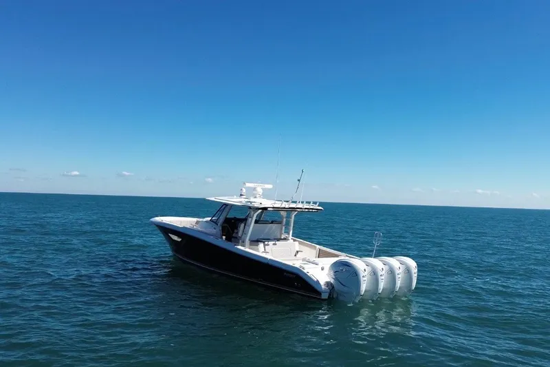 Slide: The Image of 2023 Pursuit S 428 Sport boat on open sea under clear blue sky. - 5
