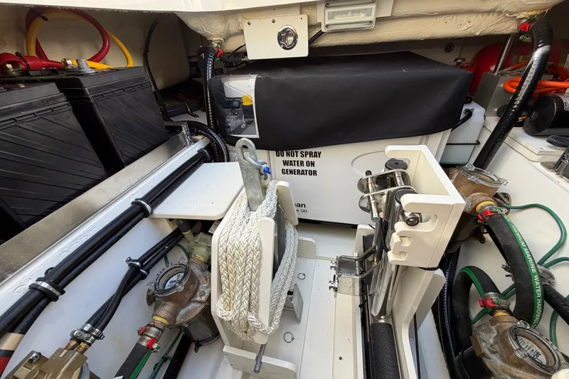 Slide: The Image of 2023 Pursuit S 428 Sport boat engine compartment with generator and wiring. - 31