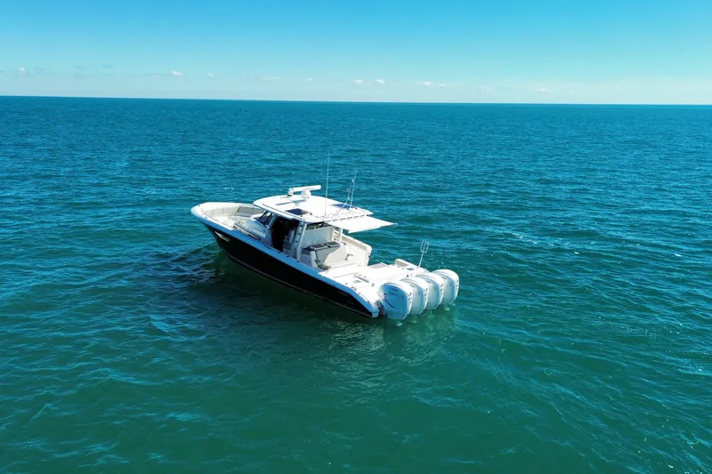 Slide: The Image of 2023 Pursuit S 428 Sport boat on open ocean under clear blue sky. - 3