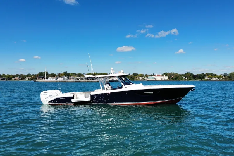 The Image of 2023 Pursuit S 428 Sport boat on clear blue water under a sunny sky. - 4