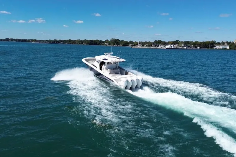 Slide: The Image of 2023 Pursuit S 428 Sport boat cruising on a clear blue lake. - 2