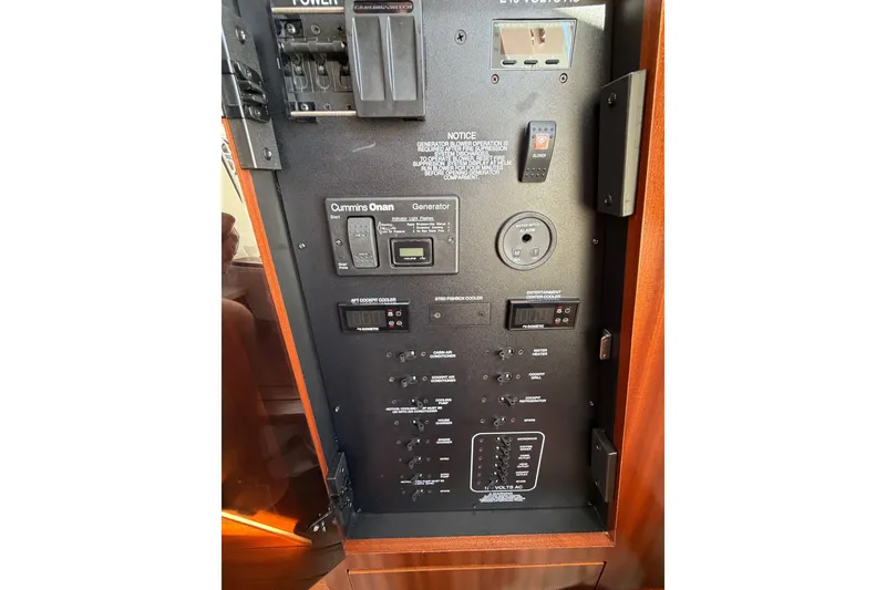Slide: The Image of Control panel of 2023 Pursuit S 428 Sport boat with Cummins Onan generator. - 23