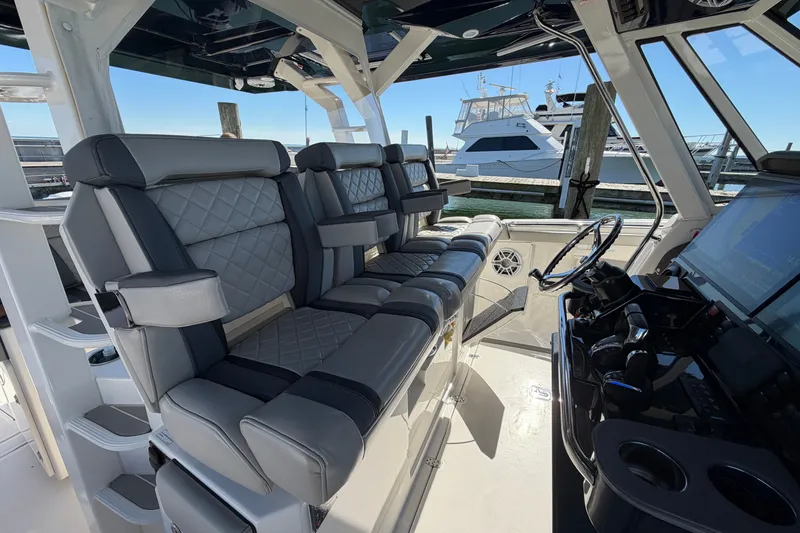 Slide: The Image of 2023 Pursuit S 428 Sport boat interior with luxurious seating and advanced helm controls. - 17