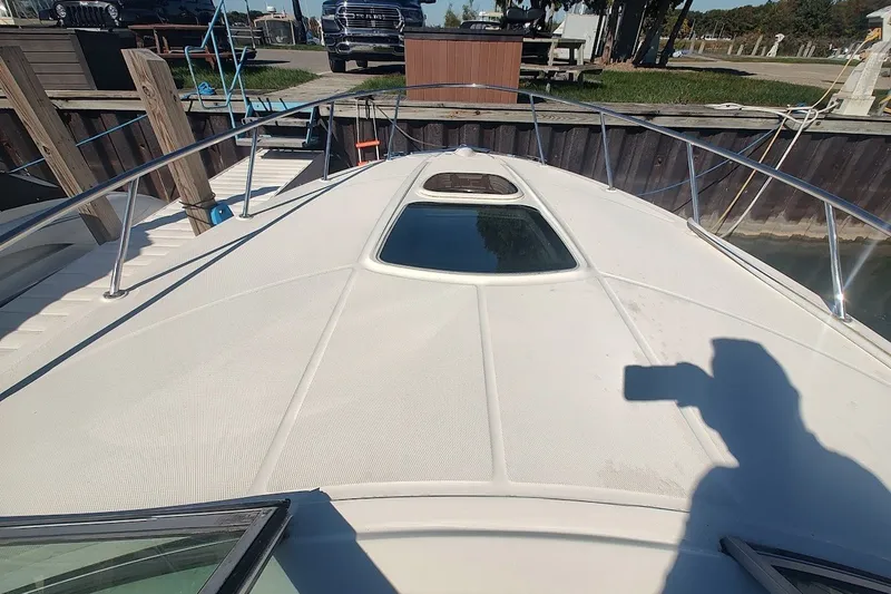 Slide: The Image of 2012 Sea Ray Sundancer 310 boat deck with railing and hatch, docked at marina. - 36