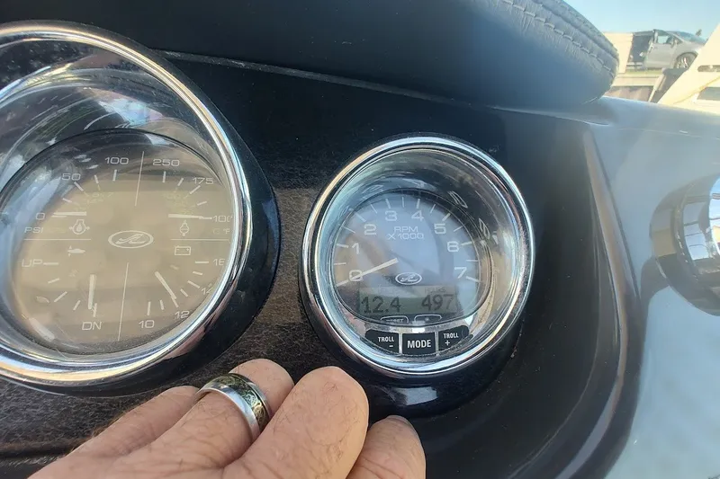Slide: The Image of Close-up of 2012 Sea Ray Sundancer 310 dashboard gauges with hand adjusting settings. - 16
