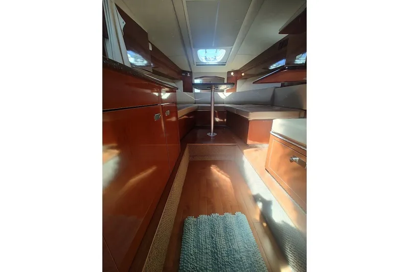 Slide: The Image of Interior of 2012 Sea Ray Sundancer 310 yacht with wood cabinetry and seating area. - 20
