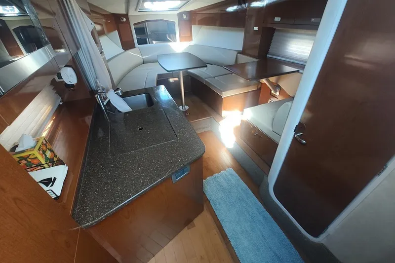 Slide: The Image of Luxurious interior of 2012 Sea Ray Sundancer 310 yacht with modern kitchen and seating area. - 21
