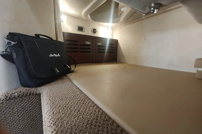 Slide: The Image of Interior cabin of 2012 Sea Ray Sundancer 310 with a black Sea Ray bag. - 26