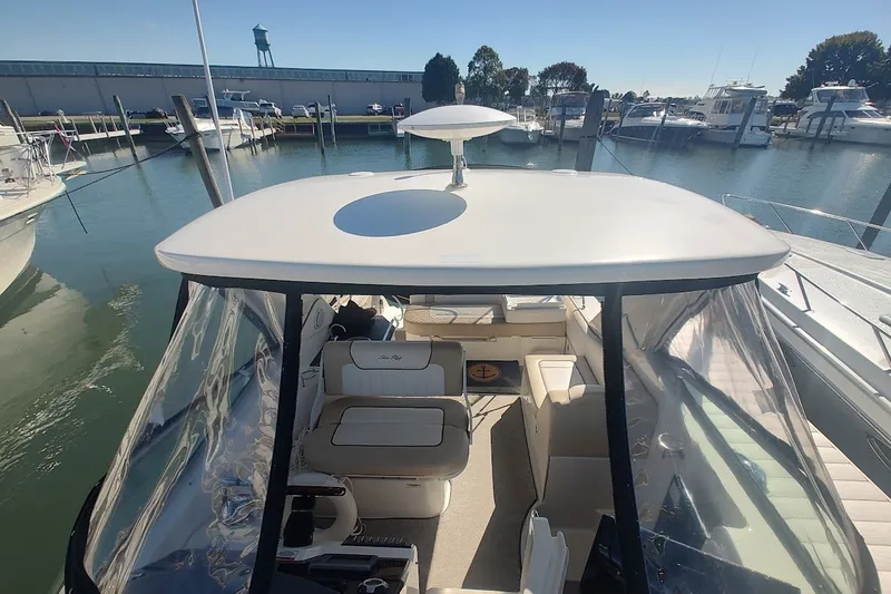 Slide: The Image of 2012 Sea Ray Sundancer 310 docked at marina, showcasing spacious interior and sleek design. - 42