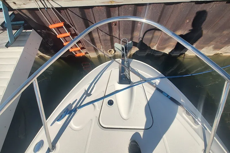 Slide: The Image of Bow of a 2012 Sea Ray Sundancer 310 docked, with visible anchor and railing. - 39