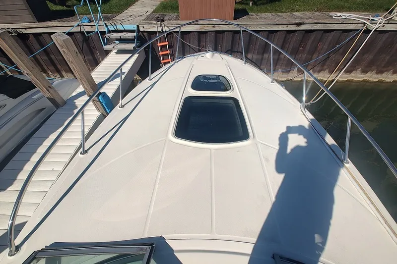 Slide: The Image of 2012 Sea Ray Sundancer 310 boat deck with hatches, docked at marina. - 37