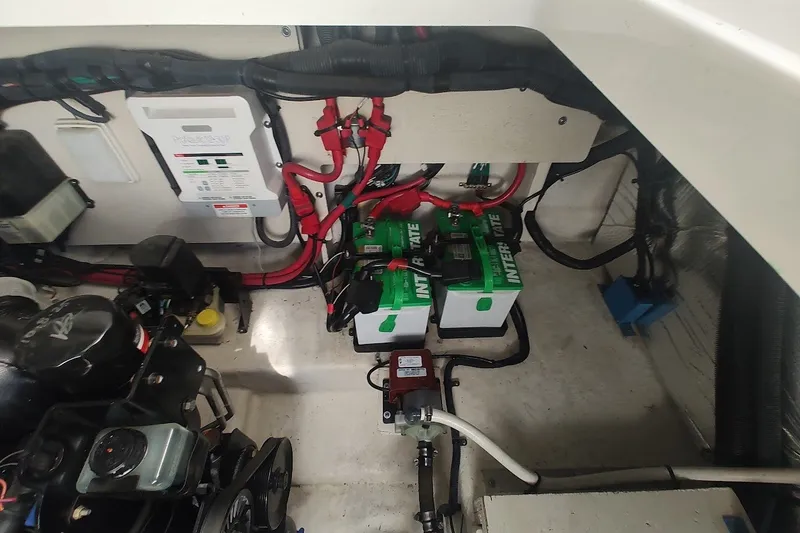 Slide: The Image of Engine compartment of a 2012 Sea Ray Sundancer 310 with batteries and wiring. - 31
