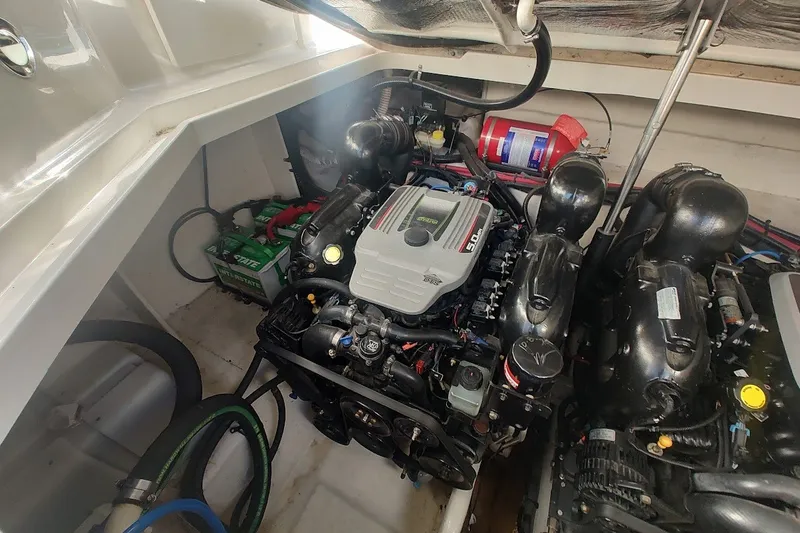 Slide: The Image of Engine compartment of a 2012 Sea Ray Sundancer 310 boat, featuring dual engines and equipment. - 34