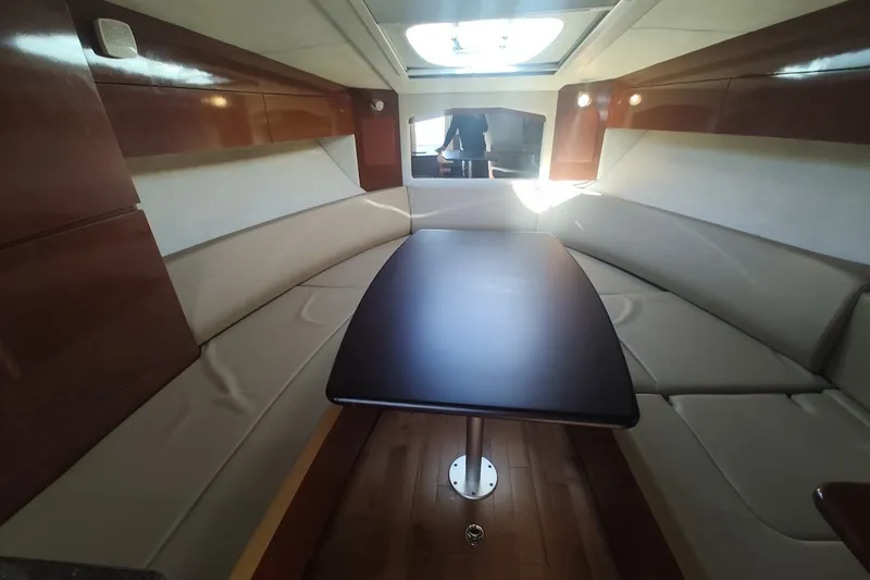 Slide: The Image of Interior of 2012 Sea Ray Sundancer 310 with elegant seating and wooden table. - 19