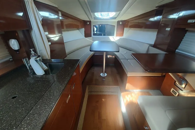 Slide: The Image of Luxurious interior of a 2012 Sea Ray Sundancer 310 yacht with elegant seating and kitchenette. - 18