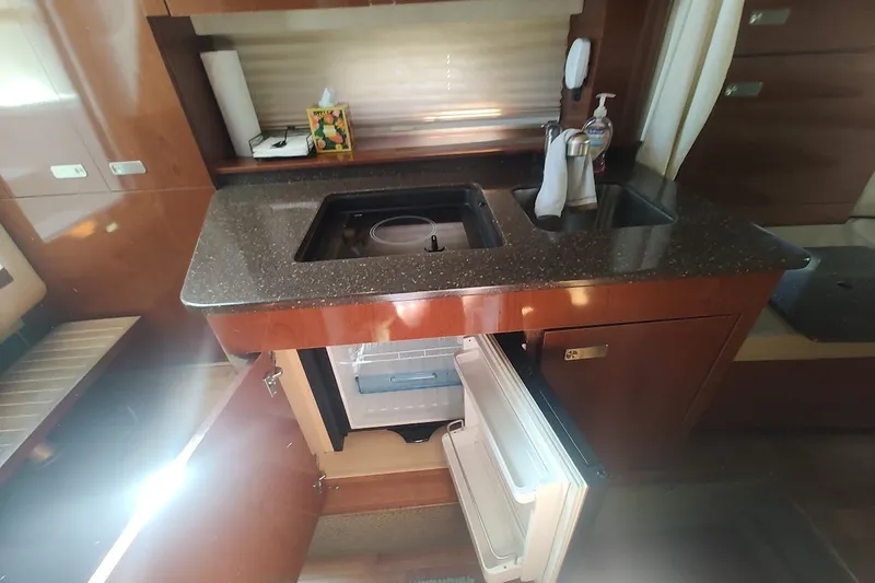 Slide: The Image of Interior of 2012 Sea Ray Sundancer 310 yacht kitchen with open fridge and sink. - 24