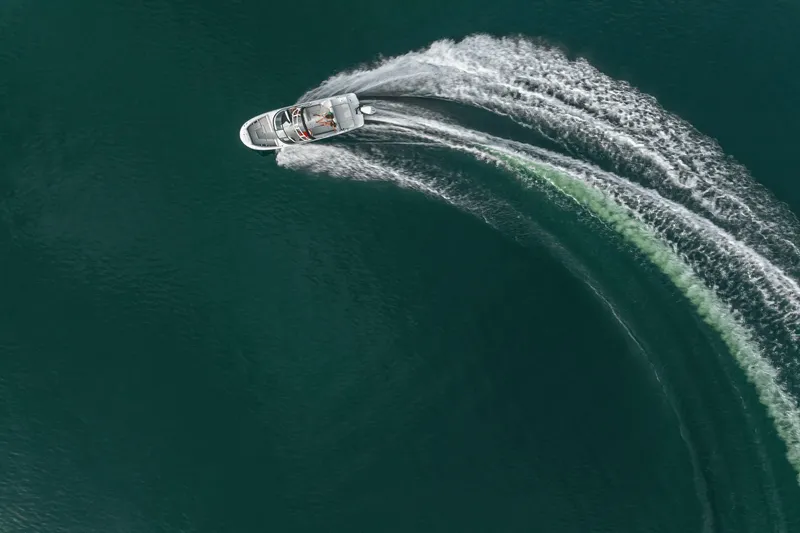 Slide: The Image of Aerial view of a Sea Ray SDX 250 Outboard making a sharp turn on the water. - 45