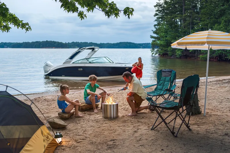 Slide: The Image of Family on beach with Sea Ray SDX 250 Outboard in the background. - 32