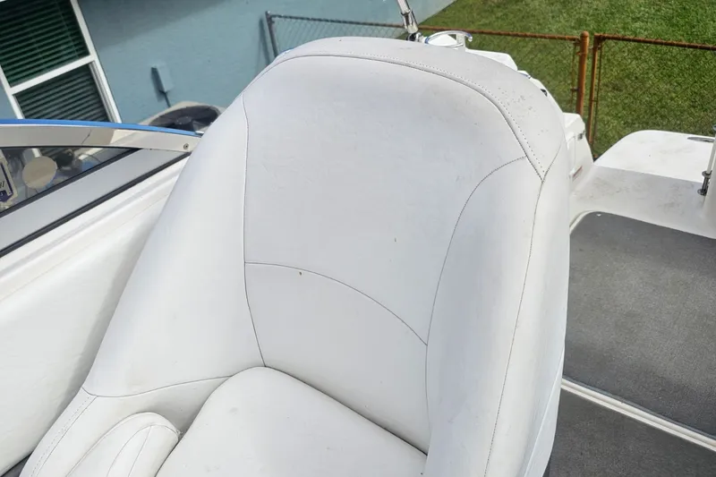 Slide: The Image of White leather seat on a 2008 Regal 2565 Express Cruiser boat. - 14