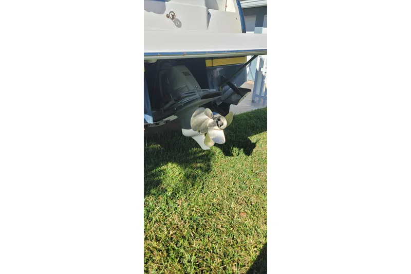 Slide: The Image of Rear view of a 2008 Regal 2565 Express Cruiser boat propeller on grass. - 8