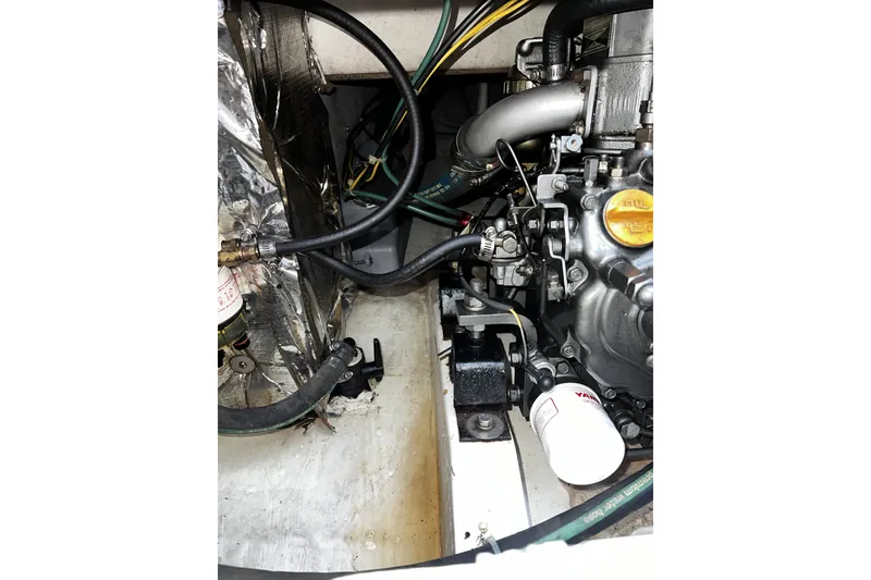Slide: The Image of Engine compartment of a 1995 Alerion Express 28 sailboat, showing mechanical components. - 41